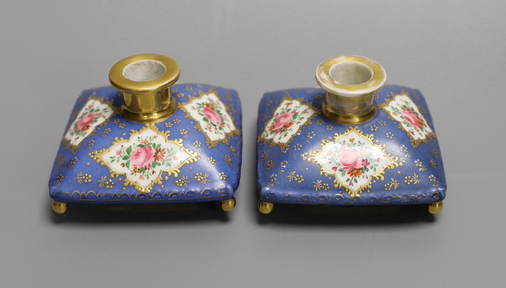 A pair of mid 19th century Paris porcelain 'cushion' shaped scent bottles decorated in Sevres style with pink roses (lacking stoppers)